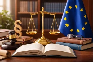 An open law book on a wooden desk featuring a golden scale of justice, a judge gavel, a section sign symbol, and the European Union flag in a library setting.